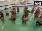 The image, taken from the Twitter video, shows dancers doing Garba while standing in a swimming pool.