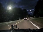 The image is taken from the Twitter video that shows a deer leaping over a car while crossing a road at night.