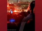 The image, taken from the Twitter video, shows the cab driver singing while stuck in traffic.
