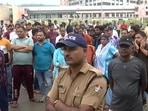 A large crowd gather outside AIIMS Rishikesh where the young reception's autopsy was conducted. (ANI Photo)