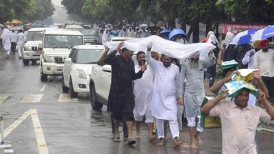 Visitors making their way to the PAU campus for the kisan mela amid heavy rain. (Gurpreet Singh/HT)