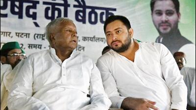 RJD Chief Lalu Prasad with younger son and Bihar deputy CM Tejashwi Yadav. (ANI) RJD Chief Lalu Prasad with younger son and Bihar deputy CM Tejashwi Yadav. (ANI)