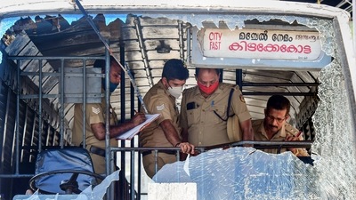Thiruvananthapuram: Police personnel take stock of the damages done to a KSRTC bus after some miscreants threw stones during a PFI shutdown (PTI) Thiruvananthapuram: Police personnel take stock of the damages done to a KSRTC bus after some miscreants threw stones during a PFI shutdown (PTI)