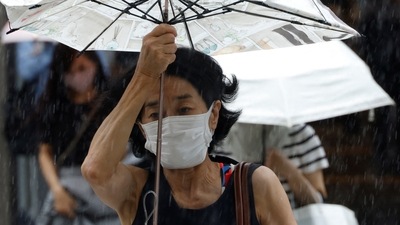 Typhoon Talas In Japan: A woman makes her way in the rain in Tokyo, Japan. (Reuters)