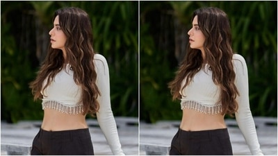 Aamna made Maldives look good in a white cropped top and a pair of black cotton trousers with multiple pockets. The cropped top featured silver embellishments around her midriff. (Instagram/@aamnasharifofficial)