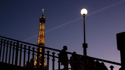 France Energy Crisis: People walk on a bridge next to the Eiffel Tower in Paris (AP) France Energy Crisis: People walk on a bridge next to the Eiffel Tower in Paris (AP)
