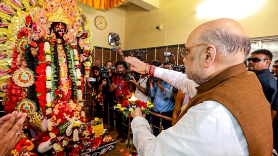 The state unit of the BJP shared a video of Shah performing "aarati" and seeking blessings of the priests at the temple, which is said to be more than 100 years old and built on land donated by a Muslim nawab.(PTI)