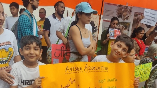 Children hold posters against animal cruelty at the Jantar Mantar in Delhi on Saturday.(HT Photo)