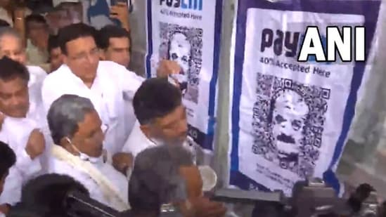 Congress leaders put up the PayCM poster on the Race Course wall in the city opposite the Volvo office.
