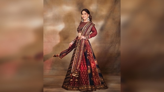 Madhuri Dixit's luxury set comes with a lehenga featuring floral detailing, a matching embroidered blouse, and a sheer dupatta with a thick border.(Instagram/@madhuridixitnene)