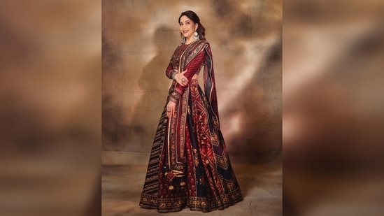 Madhuri Dixit's lehenga is made of heavy raw silk and features two shades - red and black. Sharing her photos on her Instagram handle, she captioned her post, “Maja Ma!."(Instagram/@madhuridixitnene)