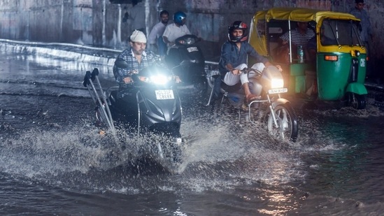 Vehicles wade through a waterlogged stretch of Pandav Nagar Underpass during heavy rain in New Delhi on Friday.(Raj K Raj/ Hindustan Times)