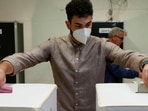 Italy Elections 2022: A man drops ballots into boxes at a polling station during the snap election, in Rome, Italy,