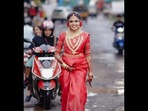 The bride from Kerala can be seen posing on a road filled with potholes. (Instagram/@arrow_weddingcompany) The bride from Kerala can be seen posing on a road filled with potholes. (Instagram/@arrow_weddingcompany)