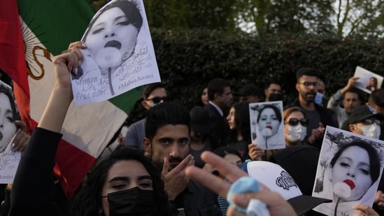 Demonstrators hold placards outside the Iranian Embassy in London, Sunday. They were protesting against the death of Iranian Mahsa Amini.(AP)