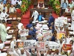 Congress and JD(S) members hold placards against government, during a legislative council session, in Vidhana Soudha. (PTI) Congress and JD(S) members hold placards against government, during a legislative council session, in Vidhana Soudha. (PTI)