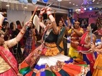 The nine-day-long festival of Navratri, which marks the victory of good over evil, has begun today, September 26 and will go on till October 5. It is held annually during the month of Ashwin (September or October). One of the main highlights of Navratri celebrations in the country is the traditional dance form 'Garba' which is a symbol of devotion and worship.(HT Photo/Santosh Kumar)