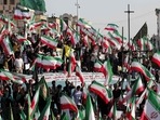 Iran Anti-Hijab Protests: Iranian pro-government protesters wave their national flag during a rally against the recent anti-government protests in Iran, in Tehran.(AFP) Iran Anti-Hijab Protests: Iranian pro-government protesters wave their national flag during a rally against the recent anti-government protests in Iran, in Tehran.(AFP)