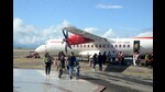 Passengers alighting from the Alliance Air flight at Jubbarhatti airport, 24km from Shimla, after flights resumed on Monday. (Deepak Sansta/HT) Passengers alighting from the Alliance Air flight at Jubbarhatti airport, 24km from Shimla, after flights resumed on Monday. (Deepak Sansta/HT)