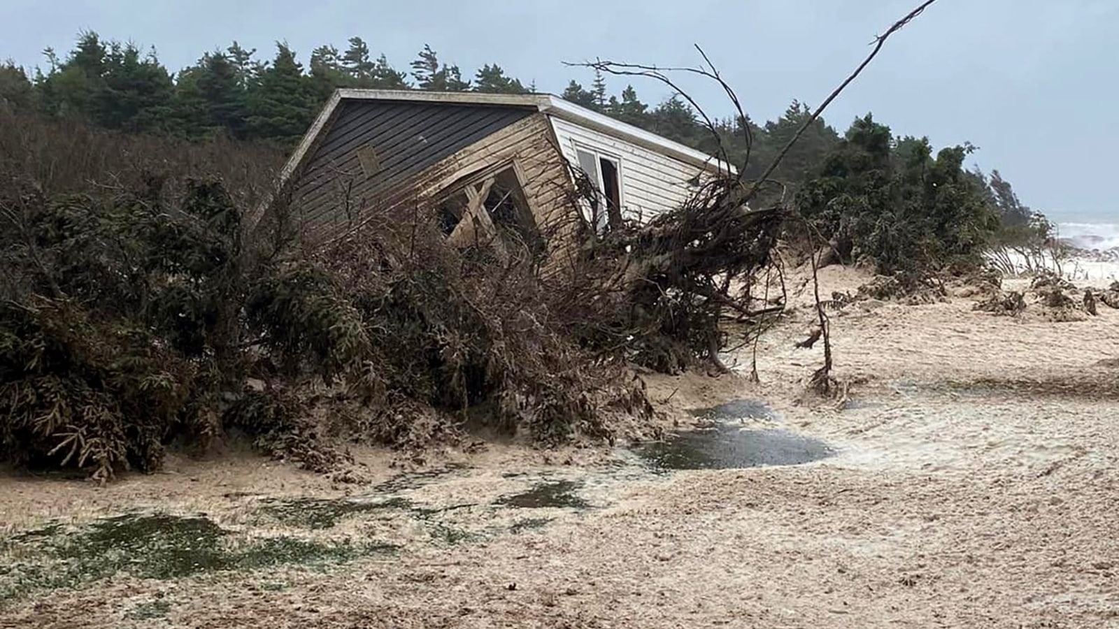 In seconds, ocean swallows Canada homes amid hurricane. Watch