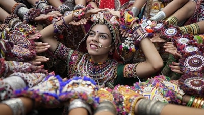 People perform Garba barefoot to pay respect to the earth, the sacred mother of all, on which all forms of humanity walk. It is also another way of connecting with the deity. (AP) People perform Garba barefoot to pay respect to the earth, the sacred mother of all, on which all forms of humanity walk. It is also another way of connecting with the deity. (AP)