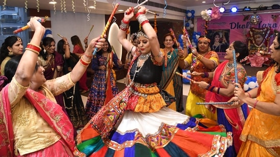 The nine-day-long festival of Navratri, which marks the victory of good over evil, has begun today, September 26 and will go on till October 5. It is held annually during the month of Ashwin (September or October). One of the main highlights of Navratri celebrations in the country is the traditional dance form 'Garba' which is a symbol of devotion and worship.(HT Photo/Santosh Kumar)