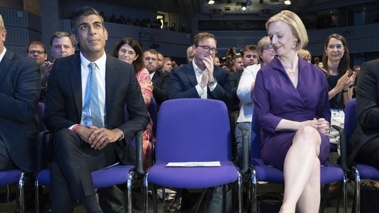 Liz Truss (right) looks across Rishi Sunak at the Queen Elizabeth II Centre in London. (AP file)