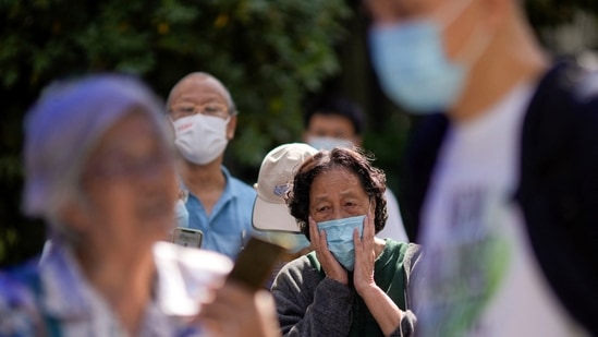 Covid In China: People line up to get tested for Covid at a nucleic acid testing site in China.(Reuters)