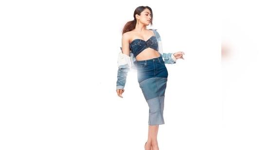 Rashmika Mandanna kept her promotional look trendy in all-denim outfit which comprises of a bandeau top, skirt and cropped jacket.(Instagram/@rashmika_,mandanna)