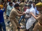 Some of them jumped into the five-foot pit near the protest sit on the university premises and policemen had to pull them out.(PTI) Some of them jumped into the five-foot pit near the protest sit on the university premises and policemen had to pull them out.(PTI)