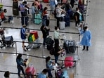 Travellers queue up for shuttle bus to quarantine hotels at the Hong Kong International Airport.&nbsp;(REUTERS/Tyrone Siu/File Photo)