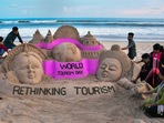 Puri: Students of Sudarsan Sand Art Institute create a sand art on the eve of World Tourism Day, at Puri beach, Monday.(PTI) Puri: Students of Sudarsan Sand Art Institute create a sand art on the eve of World Tourism Day, at Puri beach, Monday.(PTI)
