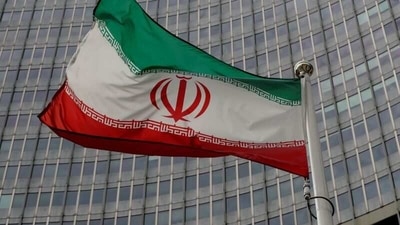 Iran Nuclear Deal: An Iranian flag flutters in front of the International Atomic Energy Agency (IAEA) headquarters in Vienna, Austria. (Reuters)