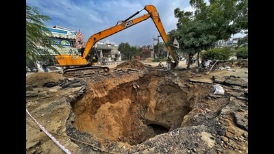 The portion of the road which caved-in near Shastri Nagar Railway Crossing in Ludhiana being repaired on Tuesday. (Gurpreet Singh/HT)