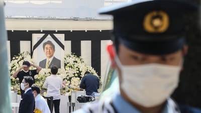 A policeman stands by as members of the public (behind) pay their respects to former Japanese prime minister Shinzo Abe. (AFP) A policeman stands by as members of the public (behind) pay their respects to former Japanese prime minister Shinzo Abe. (AFP)