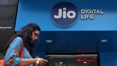 A woman checks her mobile phone as she walks past a mobile store of Reliance Jio, in Mumbai. (Reuters File) A woman checks her mobile phone as she walks past a mobile store of Reliance Jio, in Mumbai. (Reuters File)