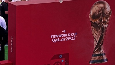 People visit a booth, set to promote this year's FIFA World Cup in Qatar. (AFP)