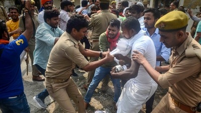 Some of them jumped into the five-foot pit near the protest sit on the university premises and policemen had to pull them out. (PTI) Some of them jumped into the five-foot pit near the protest sit on the university premises and policemen had to pull them out. (PTI)
