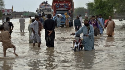 FILE - People navigate through a flooded road caused by heavy monsoon rains, in Nasirabad, a district of Pakistan's southwestern Baluchistan province. (AP) FILE - People navigate through a flooded road caused by heavy monsoon rains, in Nasirabad, a district of Pakistan's southwestern Baluchistan province. (AP)