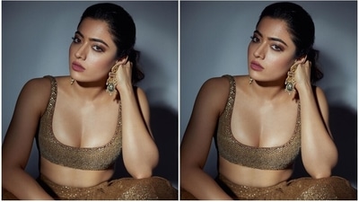 Rashmika glammed up the traditional look with statement jewellery pieces, including Kundan gold jhumkis and statement rings. A messy ponytail, dainty bindi, smoky eye shadow, mascara on the lashes, pink lip shade, beaming highlighter, and blushed cheeks completed the glam picks. (Instagram) Rashmika glammed up the traditional look with statement jewellery pieces, including Kundan gold jhumkis and statement rings. A messy ponytail, dainty bindi, smoky eye shadow, mascara on the lashes, pink lip shade, beaming highlighter, and blushed cheeks completed the glam picks. (Instagram)
