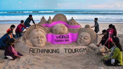 Puri: Students of Sudarsan Sand Art Institute create a sand art on the eve of World Tourism Day, at Puri beach, Monday. (PTI) Puri: Students of Sudarsan Sand Art Institute create a sand art on the eve of World Tourism Day, at Puri beach, Monday. (PTI)