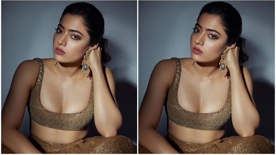 Rashmika glammed up the traditional look with statement jewellery pieces, including Kundan gold jhumkis and statement rings. A messy ponytail, dainty bindi, smoky eye shadow, mascara on the lashes, pink lip shade, beaming highlighter, and blushed cheeks completed the glam picks.(Instagram)
