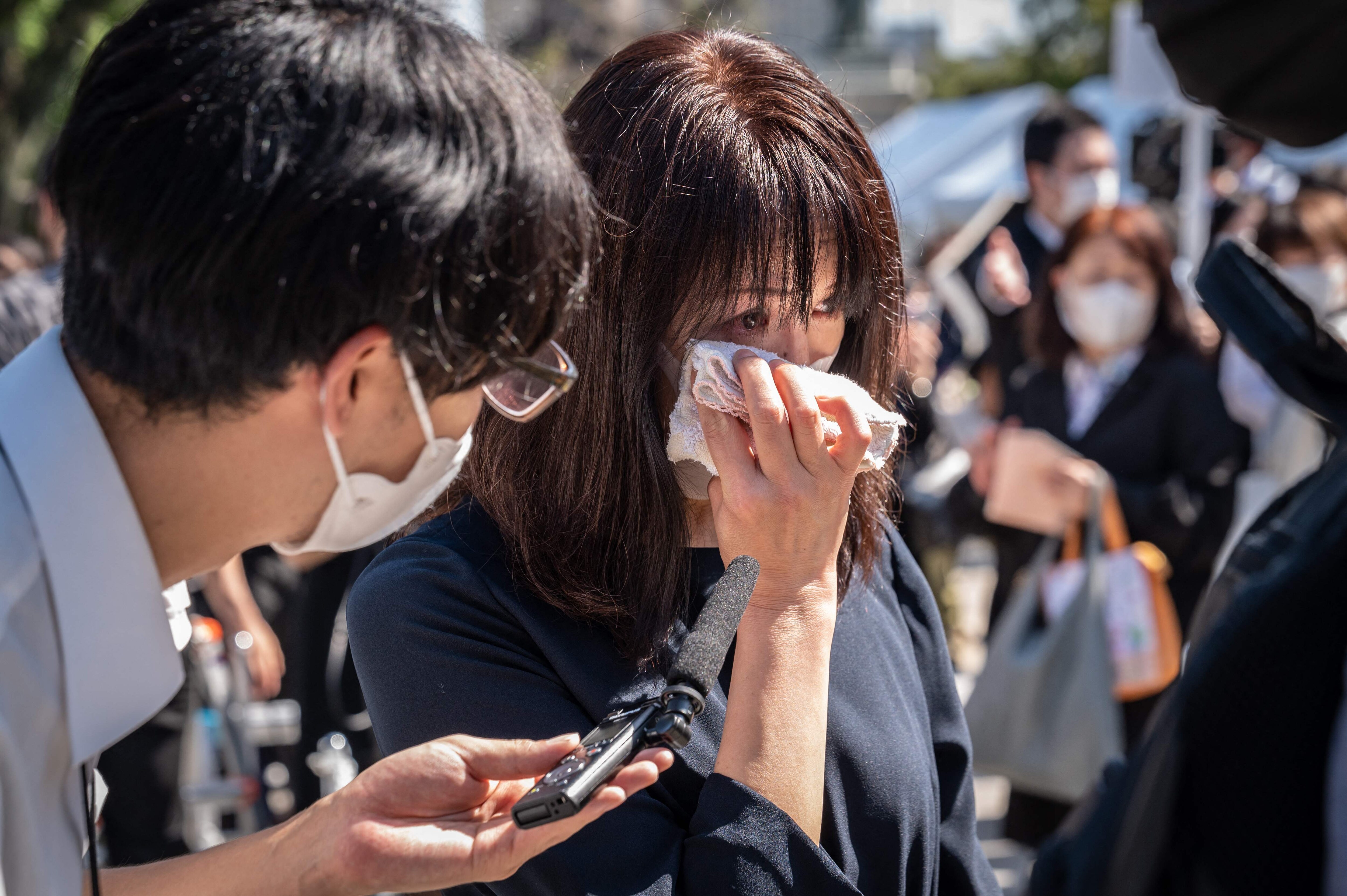Shinzo Abe State Funeral: A woman cries during an interview after flower offering in a park near the Nippon Budokan ahead of the state funeral. (AFP) Shinzo Abe State Funeral: A woman cries during an interview after flower offering in a park near the Nippon Budokan ahead of the state funeral. (AFP)