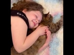 The little girl can be seen snuggling with her pet cat.&nbsp;