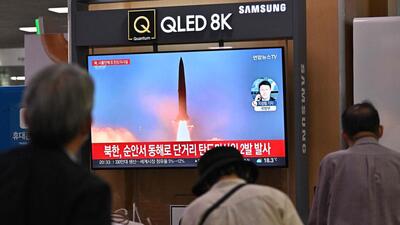 People watch a television screen showing a news broadcast with file footage of a North Korean missile test, at a railway station in Seoul on September 28, 2022. (AFP) People watch a television screen showing a news broadcast with file footage of a North Korean missile test, at a railway station in Seoul on September 28, 2022. (AFP)