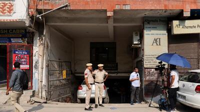 Media and policemen stand outside the office of Popular Front of India (PFI) group in New Delhi on Wednesday. (Reuters) Media and policemen stand outside the office of Popular Front of India (PFI) group in New Delhi on Wednesday. (Reuters)