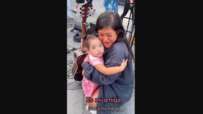 The image, taken from the Instagram video, shows the kid hugging the busker after her performance. (Instagram/@sshanilee)