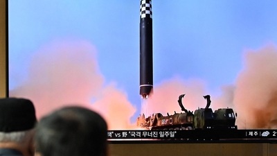 North Korea Missile Test: People watch a television screen showing a news broadcast with file footage of a North Korean missile test. (AFP File) North Korea Missile Test: People watch a television screen showing a news broadcast with file footage of a North Korean missile test. (AFP File)