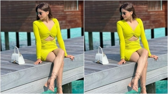Aamna’s neon green dress featured a plunging sweetheart neckline, full sleeves and a midriff-baring detail. The bodycon dress with ruched details, hugged her shape and showed off her corves.(Instagram/@aamnasharifofficial)