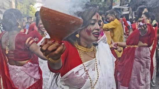 The Dhunuchi is a funnel-based open earthen pot inside which dry coconut husk sprinkled with dhuno and camphor are burnt.(HT Photo/Samir Jana)
